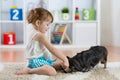 Adorable little child girl feeding cute dog Royalty Free Stock Photo