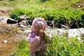 Adorable little child girl on grass on meadow. Summer green nature background. Royalty Free Stock Photo