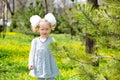 Adorable little child girl on grass on meadow. Summer green nature background. Royalty Free Stock Photo