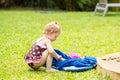 Adorable little child girl on grass. Summer green nature background. Royalty Free Stock Photo