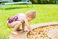 Adorable little child girl on grass. Summer green nature background. Royalty Free Stock Photo