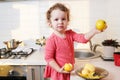 Adorable little child girl helping and baking apple pie in home``s kitchen, indoor Royalty Free Stock Photo