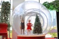 Adorable little child girl in santa costume dress playing in big winter Snow globe with reindeer on christmas time. Merry Xmas and Royalty Free Stock Photo