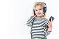 adorable little child listening music with headphones and smartphone Royalty Free Stock Photo