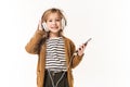 adorable little child listening music with headphones and smartphone Royalty Free Stock Photo