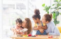 Adorable little child mould from plasticine with mother and grandmother, Grandmother and grandchildren playing cheerfully in