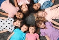 Adorable little children lying on floor together indoors. Kindergarten playtime activities Royalty Free Stock Photo