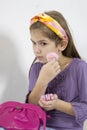 Adorable little girl applying make-up with powder- Royalty Free Stock Photo