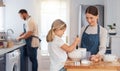 We do a lot of fun things with our free time. an adorable little girl assisting her mother while baking at home. Royalty Free Stock Photo