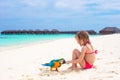 Adorable little girl at beach with colorful parrot Royalty Free Stock Photo