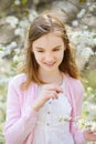 Adorable little girl in blooming apple tree garden on beautiful spring day Royalty Free Stock Photo