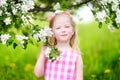 Adorable little girl in blooming apple tree garden on spring day Royalty Free Stock Photo