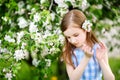 Adorable little girl in blooming apple tree garden on spring day Royalty Free Stock Photo