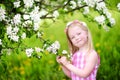 Adorable little girl in blooming apple tree garden on spring day Royalty Free Stock Photo