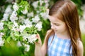 Adorable little girl in blooming apple tree garden on spring day Royalty Free Stock Photo