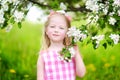 Adorable little girl in blooming apple tree garden on spring day Royalty Free Stock Photo