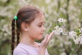 Adorable little girl in blooming cherry garden on beautiful spring day Royalty Free Stock Photo