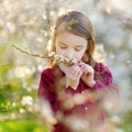 Adorable little girl in blooming cherry garden Royalty Free Stock Photo