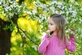 Adorable little girl in blooming cherry garden Royalty Free Stock Photo