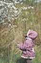 Adorable little girl in blooming cherry garden on beautiful spring day Royalty Free Stock Photo