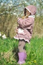 Adorable little girl in blooming cherry garden on beautiful spring day Royalty Free Stock Photo