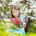 Adorable little girl in blooming cherry garden Royalty Free Stock Photo