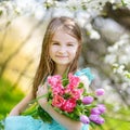 Adorable little girl in blooming cherry garden Royalty Free Stock Photo