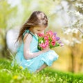 Adorable little girl in blooming cherry garden Royalty Free Stock Photo
