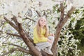Adorable little girl in blooming cherry tree garden on beautiful spring day Royalty Free Stock Photo