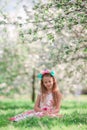 Adorable little girl in blooming cherry tree garden on spring day Royalty Free Stock Photo