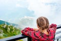 Adorable girl in the cabin on the cable car in mountains Royalty Free Stock Photo