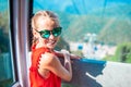 Adorable little girl in the cabin on the cable car in mountains Royalty Free Stock Photo