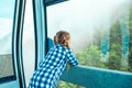 Adorable little girl in the cabin on the cable car in mountains Royalty Free Stock Photo