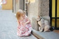 Adorable little girl and a cat outdoors