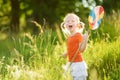 Adorable little girl catching butterflies and bugs with her scoop-net. Child exploring nature on sunny summer day Royalty Free Stock Photo