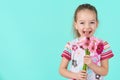 Adorable little girl with cheeky smile and face expression holding bouquet of pink gerbera daisies. Happy Mother`s Day. Royalty Free Stock Photo
