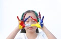 Adorable little girl closed eyes with gesture triangle colorful hands painted over white background