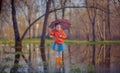 Little girl in gumboots in puddle Royalty Free Stock Photo