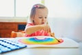 Adorable little girl drawing rainbow Royalty Free Stock Photo