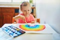 Adorable little girl drawing rainbow Royalty Free Stock Photo