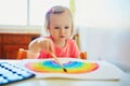 Adorable little girl drawing rainbow Royalty Free Stock Photo
