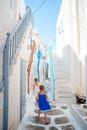 Adorable little girl at old street of typical greek traditional village Royalty Free Stock Photo