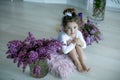 Adorable little girl dressed as a ballerina in a tutu, tying her ballet slippers. Royalty Free Stock Photo