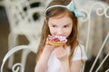 Adorable little girl eating fresh strawberry cake Royalty Free Stock Photo