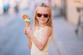 Adorable little girl eating ice-cream outdoors at summer. Royalty Free Stock Photo