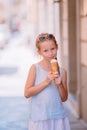 Adorable little girl eating ice-cream outdoors at summer. Royalty Free Stock Photo