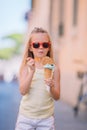 Adorable little girl eating ice-cream outdoors at summer. Royalty Free Stock Photo