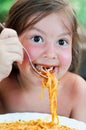 Adorable little girl eating pasta Royalty Free Stock Photo