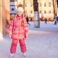 Adorable little girl enjoying skating at the ice-rink Royalty Free Stock Photo