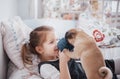 Adorable little girl feeding cute pug. She bought a puppy. the best friend Royalty Free Stock Photo